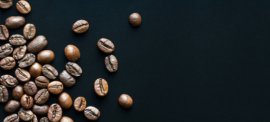 roasted coffee beans on black background with space for text, macro