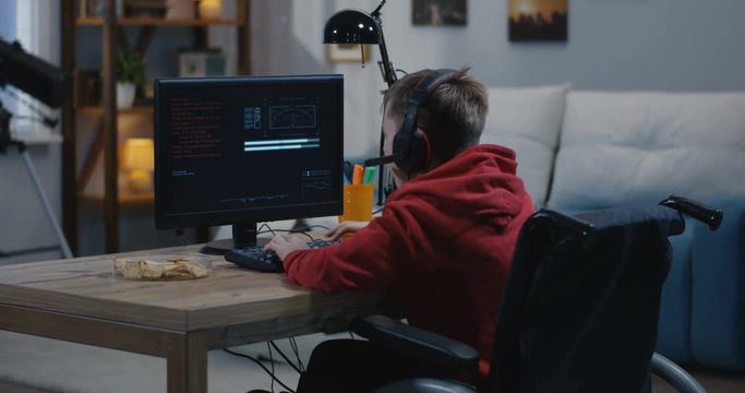 Disabled boy hacking on his computer