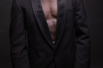 Beautiful and muscular black man in dark background.