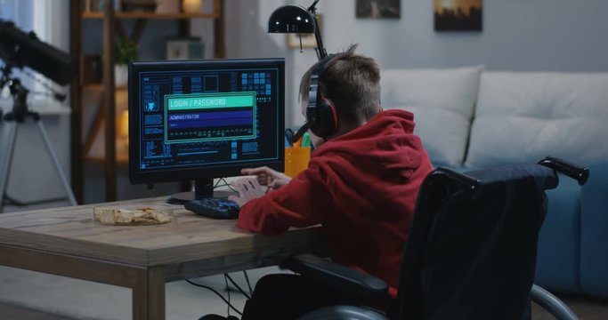 Disabled boy hacking on his computer