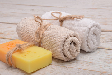 Obraz na płótnie Canvas gift for mother's day, hand-made soap with fruit aromas next to towels with free space for text