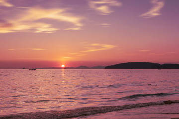 Fototapeta na wymiar Tropical sunset over horizontal, Watching sunset on the beach. Ao Nang beach. Holiday in Krabi. South of Thailand
