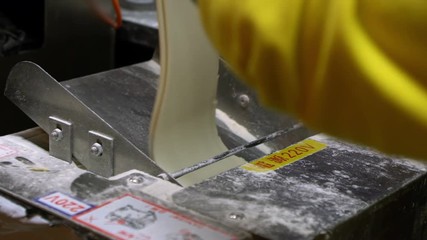 Slow Motion of man hands cook and prepairing dough of dumpling in a industrial machine. Asian chef making fresh dumplings in restaurant. Traditional taiwanese food in the night market of Taiwan.-Dan - Powered by Adobe
