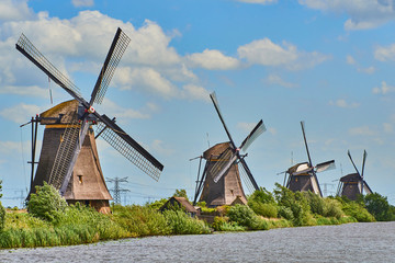 Fototapeta premium Netherlands rural lanscape with windmills at famous tourist site Kinderdijk in Holland. Old Dutch village Kinderdijk, UNESCO world heritage site. 