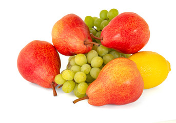 Yellow lemon and some bright appetizing tasty red pears with a bunch of green grapes