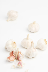 A few heads of garlic on a white background. Top view.