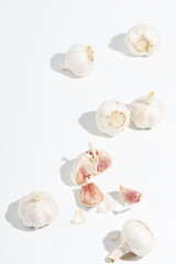 A few heads of garlic on a white background. Top view.