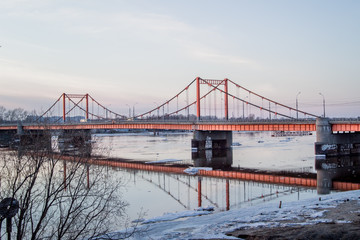 Fototapeta na wymiar Ice drift in Arkhangelsk on the river. evening, sunset, bridge, car