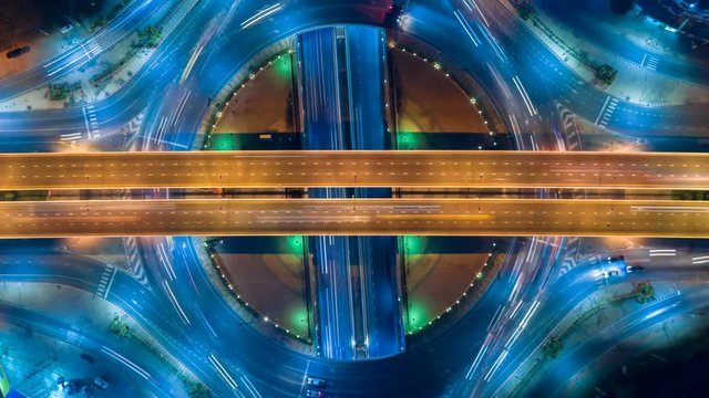 Hyperlapse timelapse of night city traffic on 4-way stop street intersection circle roundabout in bangkok, thailand. 
