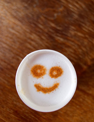 happy face take away coffe on wooden background, space for text