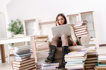 Young female student preparing for exams at home 