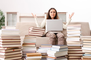 Young female student preparing for exams at home 