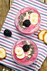 Blackberry oats banana smoothie on a wood background