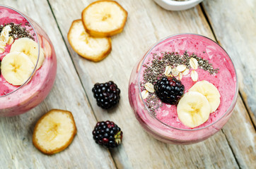 Blackberry oats banana smoothie ona wood background