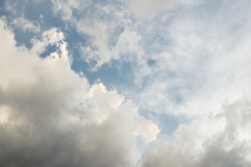 Storm clouds build against blue sky