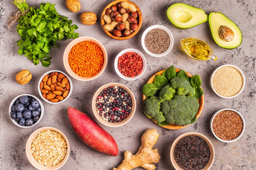 Superfoods on gray concrete background. Top view.