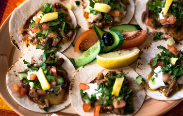 Mexican tacos with minced meat, beans and spices on a plate