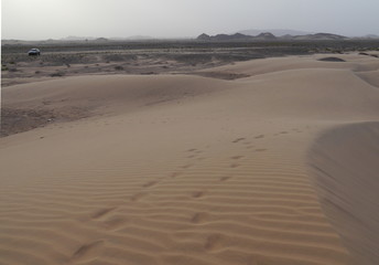 sunset atmosphere with desert and mountains during a jeep tour near Nizwa, Oman, Middle East