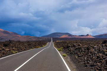 Road to Timanfaya with a storm in the background, over the volcanoes