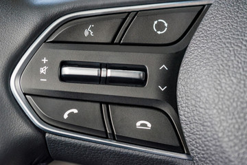 Naklejka premium Phone control buttons on the steering wheel close
