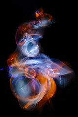 The abstract image painted by moving light and moving objects on a black background. Color abstraction.