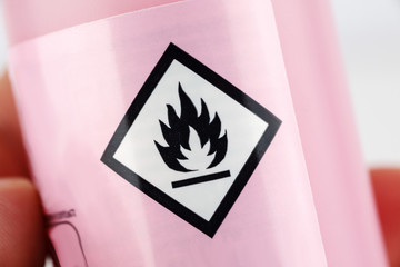 Flammable sign on a bottle, macro shot