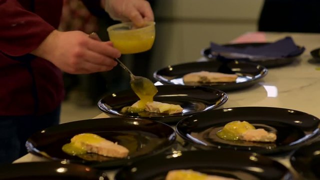 Adding sauce to the salmon