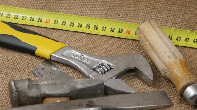 Old locksmith tools laid out on the burlap, background