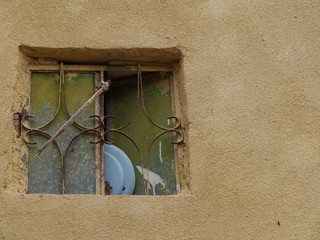 still life with single blue plate leaning off opened old window, abandonment concept