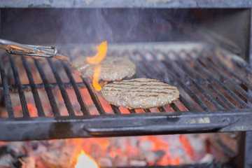 cheeseburger cutlets is cooked in josper on the background of burning coal for a holiday party.