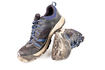 dirty used worn out black outdoor sneakers isolated on white