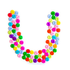 Letter U of the English alphabet made of multi-colored buttons