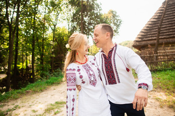 Young couple in a traditional Ukrainian clothing, have fun spending time in the Park