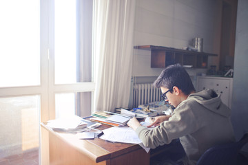 Young boy studying at a desk.