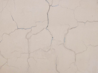 Cracks on the plastered wall surface. Abstract background texture concept