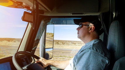 Truck drivers big truck right-hand traffic of driver's hands on big truck steering wheel