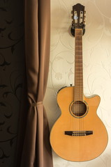 Obraz na płótnie Canvas classiс acoustic guitar on the wall 