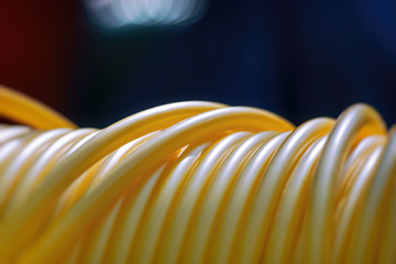 Optic cable drum with yellow fiber cords in closeup