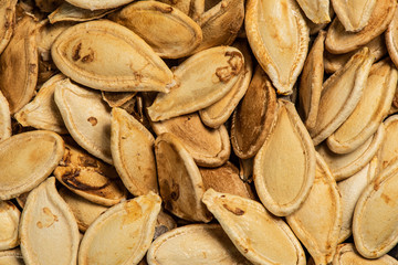 Roasted pumpkin seeds, fried in oven, macro, top view