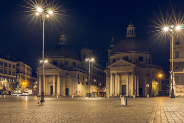 Fototapeta na wymiar Piazza del Popolo or Peoples Square with twin churches Santa Maria di Monte Santo, Santa Maria dei Miracoli and Obelisk is one of the most famous squares in Rome heading south at night and lighting