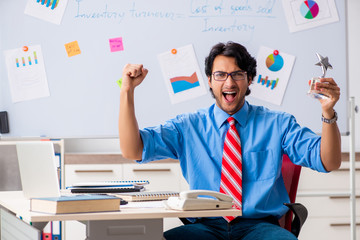 Young male financial manager working in the office 