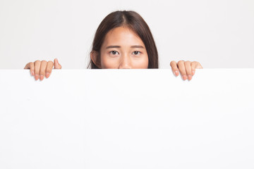 Fototapeta premium Close up of young Asian woman behind a blank sign.