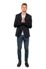 Blonde handsome man keeps palm together. Person asks for something