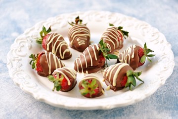 Delicious fresh strawberries in milk and white chocolate.