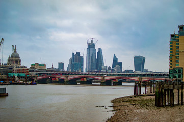 Bridge on river thames and tall buildings