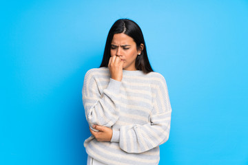 Young Colombian girl with sweater having doubts