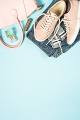 Woman fashion cloth set and accessories on blue.