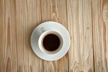 Hot coffee on a wooden stand, top view