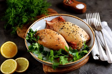 Fresh stuffed squids with rice and mushrooms baked in the oven.