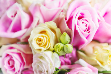 Bridal bouquet with pink and yellow roses. Traditional floral composition for wedding ceremony. Romantic symbol of love and marriage.